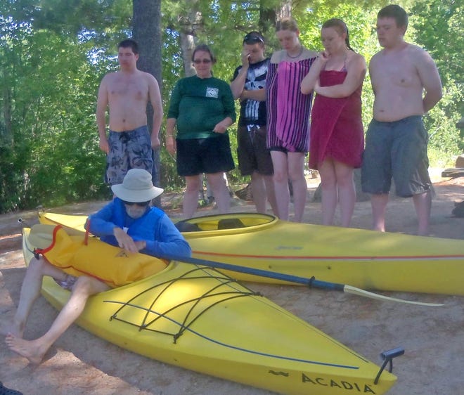 Last Saturday, at John’s Beach, Sue Dooley and Venture Crew members listened attentively while Kimo demonstrated the use of a floatation pillow attached to an oar. This was the second training session for them in preparation to camping and kayaking for a week at Webb Cove, Maine. Kimo explained the pillow would be used to stabilize a kayak to get back in if capsized. Pictured from left are Kimo, Brian Dow, Sue Dooley, Mike Hussey, Libby Brooks, Danielle Baker, and Ricky Whitehouse.