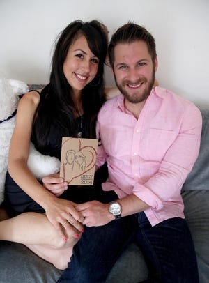 Anthony Spizuoco and Lisette Saavedra of San Francisco with one of their hand-drawn wedding invitations. The couple are sharing the burden of planning their wedding.