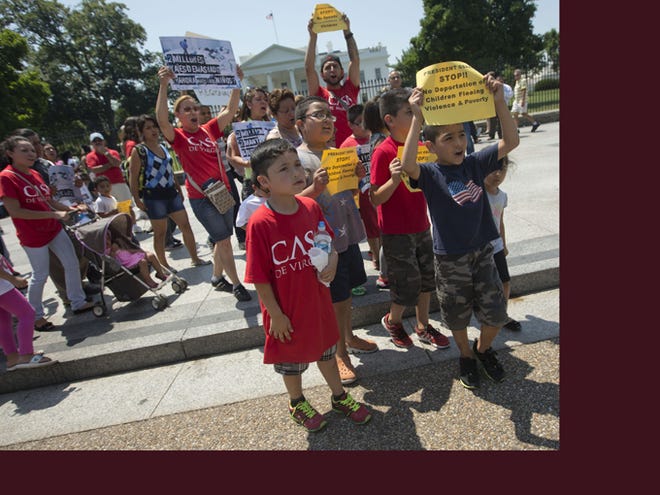 Demonstrators march Monday in front of the White House in Washington, following a news conference of immigrant families and children's advocates responding to the President Barack Obama's response to the crisis of unaccompanied children and families illegally entering the U.S. A top Obama administration official says no one, not even children trying to escape violent countries, can illegally enter the United States without eventually facing deportation proceedings.