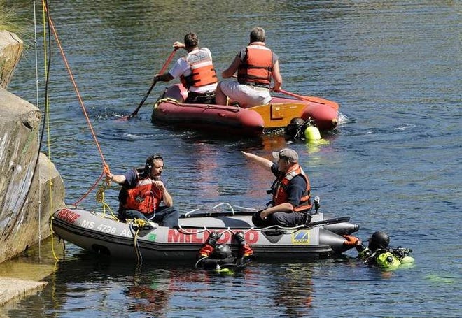 Milford firefighters and divers search a quarry Sunday for a missing swimmer, who authorities say is a Rhode Island teenager.