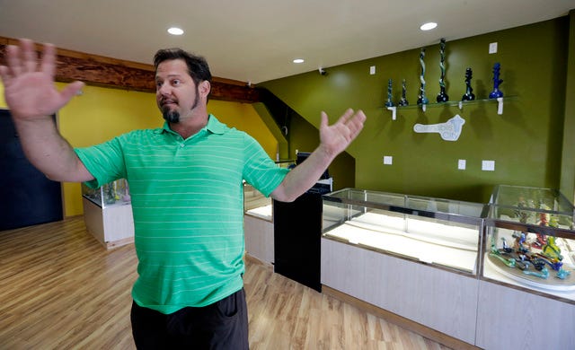 THE ASSOCIATED PRESS / Cannabis City owner James Lathrop gestures as he stands in the middle of his new marijuana shop days before the grand opening Wednesday, July 2, 2014, in Seattle. Empty display cases behind him are expected to be filled with pot for sale beginning Tuesday, July 8, the first day that recreational marijuana can legally be sold in Washington state. Lathrop is expected to be the first licensed retailer in Seattle. (AP Photo/Elaine Thompson) 
 THE ASSOCIATED PRESS / Cannabis City owner James Lathrop briefly stands outside his business, with a temporary sign over the mail slot, in between media interviews Wednesday, July 2, 2014, in Seattle. Lathrop expects to be begin selling pot Tuesday, July 8, the first day that recreational marijuana can legally be sold in Washington state. Lathrop is expected to be the first licensed retailer in Seattle. (AP Photo/Elaine Thompson) 
 THE ASSOCIATED PRESS / A consumer's guide to marijuana use, published by the Washington State Liquor Control Board, sits on a counter at the Cannabis City marijuana retail shop days before the grand opening Wednesday, July 2, 2014, in Seattle. Pot is expected to go on sale beginning Tuesday, July 8, the first day that recreational marijuana can legally be sold in Washington state. The shop is expected to be the first licensed retailer in Seattle. (AP Photo/Elaine Thompson)