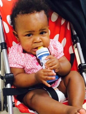 This undated image provided by the NYPD shows a baby in a stroller abandoned in a subway station in New York, Monday, July 7, 2014. New York City police say they are searching for a woman who pushed the baby's stroller onto the platform when the northbound No. 1 train arrived at the Columbus Circle station. Then she got back onto the train.