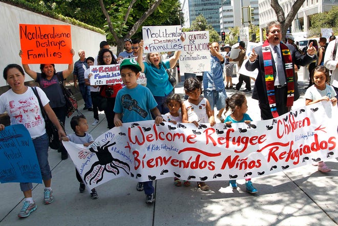 Immigrant families and children's advocates rally in response to President Barack Obama's statement on the crisis of unaccompanied children and families illegally entering the United States, outside the Los Angeles Federal building on Tuesday.