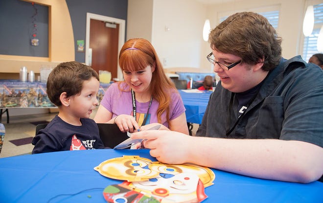 Liz Rice, center, and Matt Moffit, right, of Zeldathon, visit with a patient at St. Jude Children Research Hospital in Memphis in January. The Meadville-based gamers will play an online game marathon to benefit the hospital beginning Thursday. CONTRIBUTED/