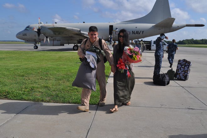 AWV2 Esteban Moreno of VP-8 and his wife, Yara, walk together to NAS Jacksonville Hangar 117, after he arrived home from a seven-month deployment.