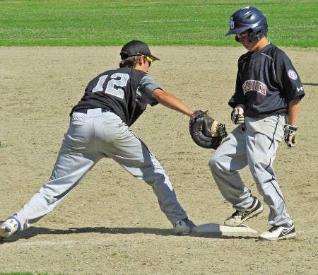 Mike Zhe photo
Max Malila (right) of Portsmouth gets back to first base on a pick-off try by Exeter’s Ryan Huppe during the sixth inning of Wednesday’s game in the 13-year-old Babe Ruth district tournament in Rochester. Portsmouth won, 10-3.