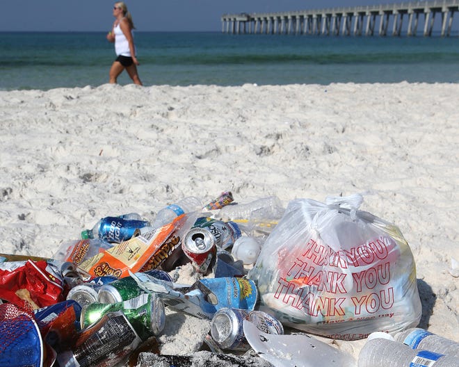 Trash left from the holiday weekend is piled up near the M.B. Miller County Pier in Panama City Beach on Monday morning.