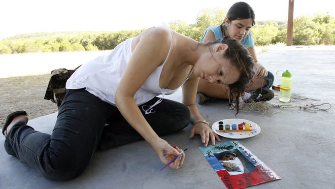 Natalie Noriega, 16, paints on paper framing a photo of her brother, Chad, at Camp Brave Heart at John Knox Ranch in 2009. Noriega’s brother passed away during a car accident in 2005.