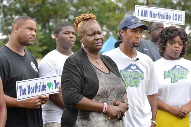Bruce.Lipsky@jacksonville.com Linda Dayson (center), Leandrew Mills III (second from right) and Pervalia Gaines-McIntosh were among those at Saturday's rally calling for an end to the violence.