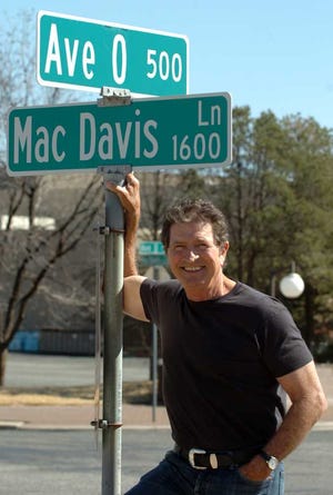 Mac Davis poses at Mac Davis Ln. and Ave O. (Staci Gray)