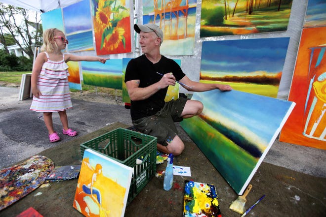 Madelyn Bracken, 5, of Boston, points to where she thinks Mike Bryce, of Providence, should paint next. Bryce was working on, and selling, oil and acrylic paintings of Rhode Island scenes Saturday at the Wickford Art Festival.