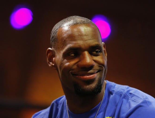 NBA basketball star LeBron James attends a promotional event at Phenom House, in Rio de Janeiro, Brazil, Saturday, July 12, 2014. James who will attend the final game of the 2014 soccer World Cup, has announced his return to play for the Cleveland Cavaliers after four years in Miami.