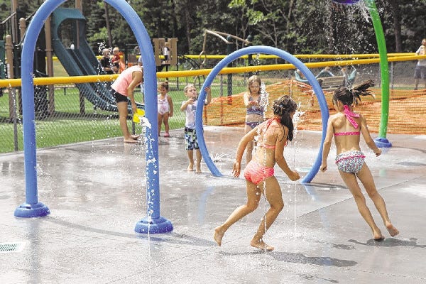 Children enjoy the newly installed splash pad at Heritage Park in Mashpee. The pad is handicapped accessible, fenced off for safety and near a shaded pavilion.