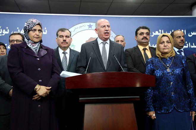 Iraqi former Parliament speaker and the chairman of the Sunni Arab Coalition Osama al-Nujaifi, center, speaks to the media during a press conference in Baghdad, Iraq, Sunday, July 13, 2014. Iraq's deadlocked parliament ended its second session after just 30 minutes Sunday without making any progress toward forming a new government that can unite the country and confront the Sunni militant blitz that has seized control of a huge chunk of the country.