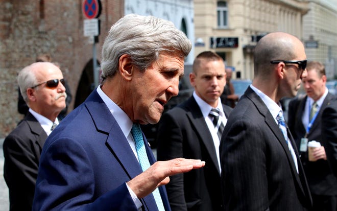 U.S. Secretary of State John Kerry talks to media in front of a hotel where closed-door nuclear talks on Iran take place in Vienna, Austria, Sunday, July 13, 2014. Kerry and fellow foreign ministers are adding their diplomatic muscle to nuclear talks with Iran, with a target date only a week away for a pact meant to curb programs Tehran could turn to making atomic arms.