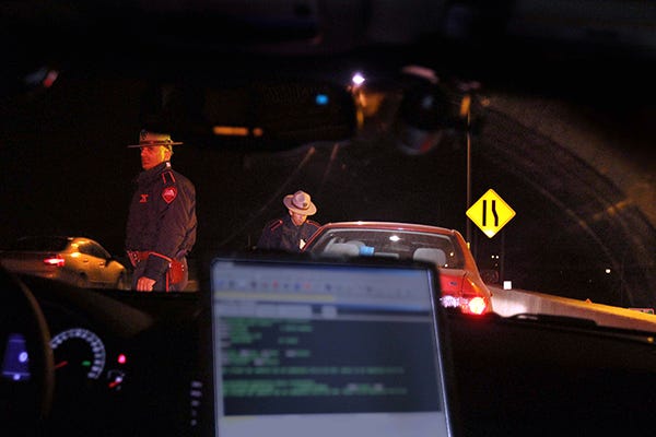 Lincoln---Dec. 27, 2013---Rhode Island State trooper Kevin Cloud watches traffic along rt 146 while trooper Franklin Navarro, talks to the driver of a car stopped for speeding. The troopers were conductingf DUI stops along route 95 and 195 Friday night. Although no one was stopped for DWI, this driver was stopped for speeding on 146. The Providence Journal/Steve Szydlowski