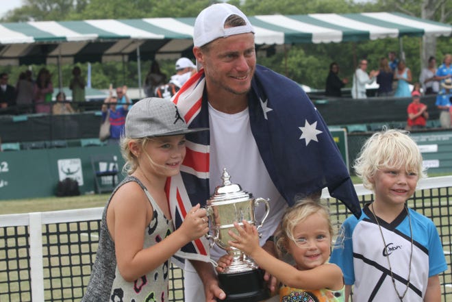 Lleyton Hewitt is joined on the court by his three children — from left, Mia, 8; Ava, 3; and Cruz, 5 — after winning the men’s singles final on Sunday at the International Tennis Hall of Fame.