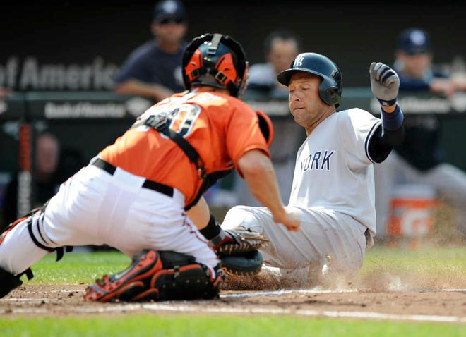 New York Yankees runner Derek Jeter, right, is tagged out at home by Baltimore catcher Nick Hundley on Saturday in Baltimore.