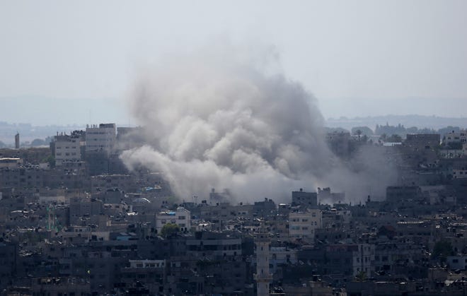 Smoke rises after an Israeli missile strike in Gaza City on Monday.