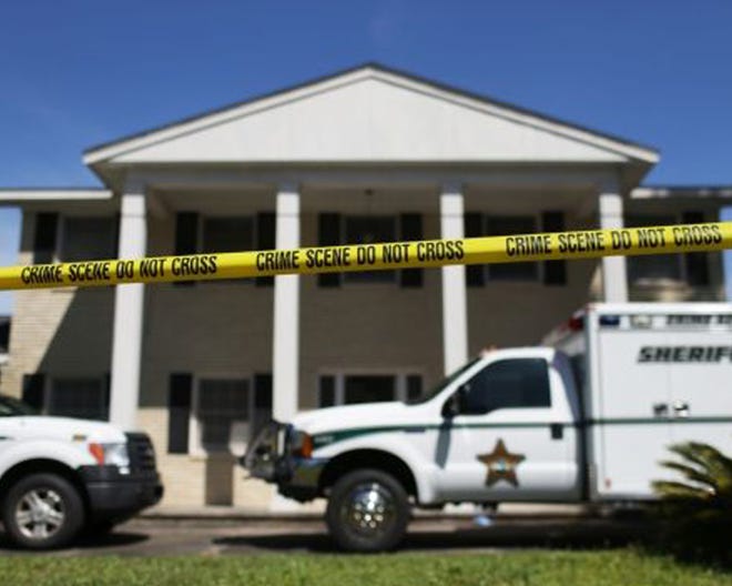 Crime scene tape surrounds Wallace Reid Scott’s home on Pinetree Road in Lynn Haven in April of 2013.