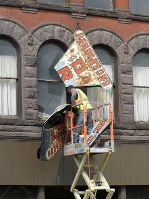 People of Penn Yan were shocked July 9 to see a crew demolishing the Henderson’s Drug Store sign.