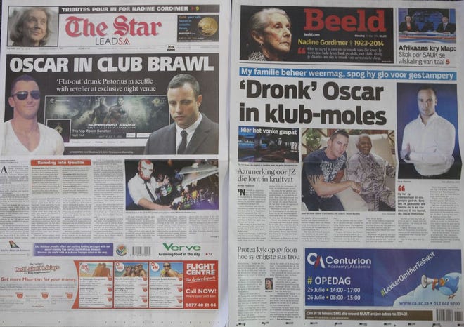 Two Johannesburg newspapers report Tuesday, July 15, 2014 on how Oscar Pistorius, right, who is accused of the murder of his girlfriend, recently visited a nightclub with a cousin and was allegedly accosted by a man, Jared Mortimer, left and center, who aggressively questioned him about his murder trial, his family said Tuesday. A spokeswoman for the Pistorius family said an argument followed and the athlete, who is free on bail, soon left the club. He had been seated in a quiet booth in the VIP section, she said in a statement. Afrikaans headline reads "Drunk Oscar in club altercation. (AP Photo/Denis Farrell)