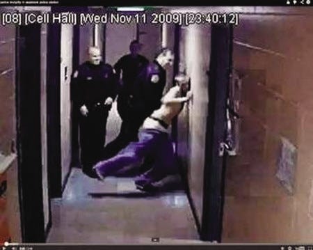 Michael Bergeron Jr. is slammed into a wall at the Seabrook Police Department, as seen in this image from a 2009 incident posted in a YouTube video.