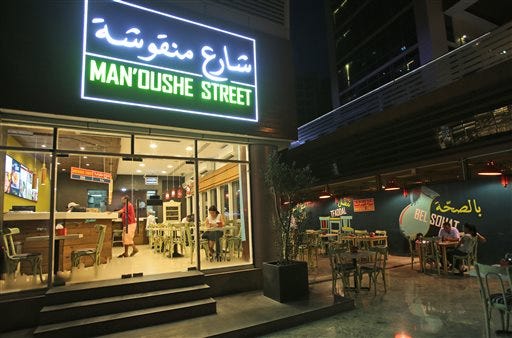People dine in May at one of the branches of the Man'oushe Street restaurant in Dubai, United Arab Emirates. Mideast entrepreneurs who have taken on international competition are now turning the tables, exporting local foods including falafel and premium dates overseas and proving that the globalization of food isn’t a one-way drive-thru lane.