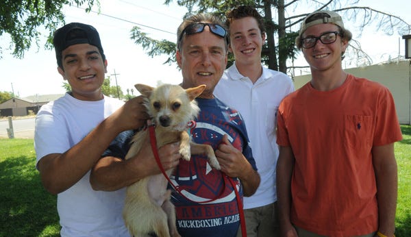 “Jimmy Buffett” is surrounded by his saviors, Haider Shah, from left, Donald Wesley, Ben Miller and Dilllon Tatum, who rescued him from a small Delta island last week.