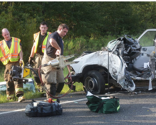 Bay County Fire/Rescue personnel carry the Jaws of Life away from the scene of a two-vehicle wreck that killed one driver and critically injured at least one other person on U.S. 231 south of Camp Flowers Road on Wednesday.