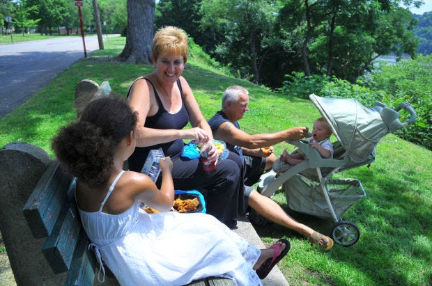 Mark and Pam Locke of Rochester enjoy a lunch break with their grandchildren, Kamryn Newman, left, and Adam Spearing, along River Road in Beaver on Friday. The Lockes said they never had a problem with their own kids but can see how easily children can be injured and killed when climbing on heavy furniture.