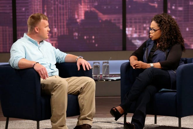 Matt Sandusky, the adopted son of former Penn State University assistant football coach Jerry Sandusky, talks with Oprah Winfrey during a show that aired Thursday.