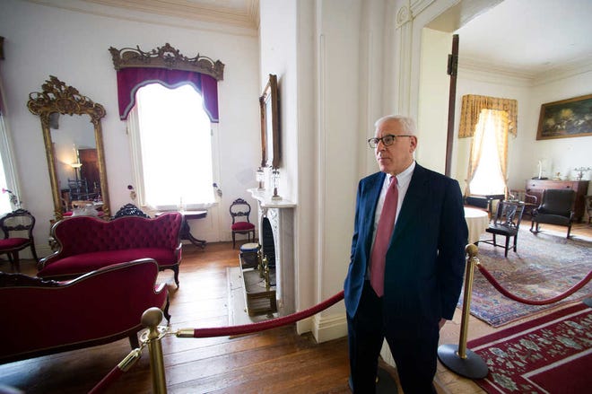 Philanthropist David Rubenstein walks through the historic Arlington House at Arlington National Cemetery in Arlington, Va., Thursday, July 17, 2014. The historic house and plantation originally built as a monument to George Washington overlooking the nation's capital that later was home to Confederate Gen. Robert E. Lee and 63 slaves will be restored to its historical appearance after a $12.3 million gift from Philanthropist David Rubenstein. (AP Photo/Cliff Owen)