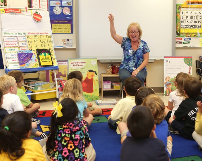 Substitute teacher Ellen Benton tells a Breakfast Point Elementary kindergarten class a story in September 2013 in Panama City Beach. Bay District Schools is changing its policy on who can become substitutes.