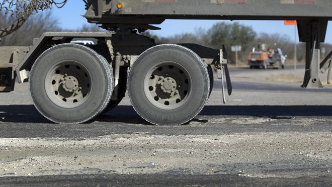 FILE PHOTO: A truck drives down Texas 72 at the intersection of Texas 97. With fracking in the Eagle Ford Shale region bringing an influx of heavy trucks, the roads are showing signs of wear.