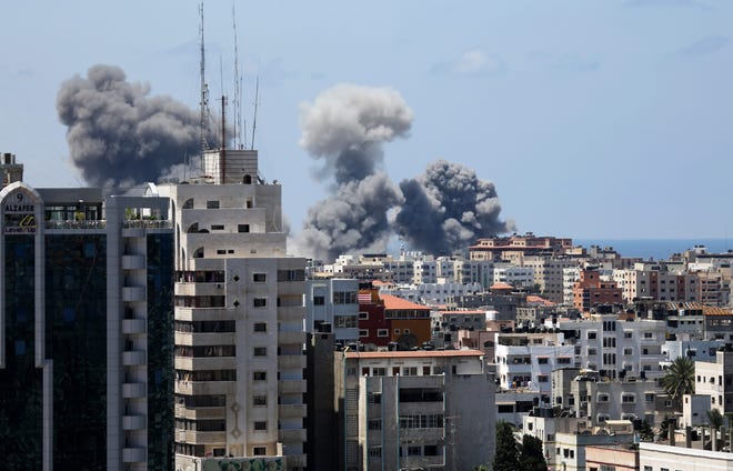 Smoke rises after an Israeli missile strike in Gaza City, Friday, July 18, 2014. Israel intensified its 11-day campaign against Hamas by sending in tanks and troops late Thursday after becoming increasingly exasperated with unrelenting rocket fire from Gaza on its cities, especially following Hamas' rejection of an Egyptian cease-fire plan earlier in the week.