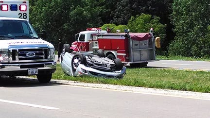 A 2000 Chrysler 300 lies upside-down after a rollover crash Friday afternoon on U.S. 34, between Monmouth and Cameron. The driver and two passengers were treated for non-life threatening injuries, according to state police. TINA FELL/REVIEW ATLAS