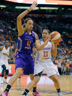 East's Shoni Schimmel (23), of the Atlanta Dream, looks to shoot around West's Brittney Griner, of the Phoenix Mercury, during the first half the WNBA All-Star basketball game, Saturday, July 19, 2014, in Phoenix. The East won 125-124 in overtime. (AP Photo/Matt York)