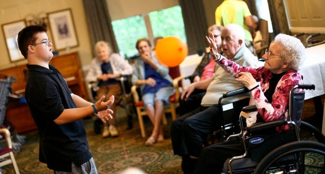 Teddy Hunter, 20, of Braintree High School’s Project PROVE uses a balloon to play with 98-year-old Elizabeth Brymer at Alliance Healthcare. The photo was taken on Wednesday July 16, 2014.