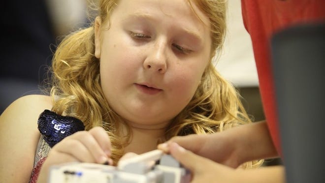 Ten-year-old Gabi Smith (left) of Jupiter works on a RoverBot with 9-year-old Spencer Sasson (right) of Loxahatchee during Google Maker Camp at the South Florida Science Center & Aquarium on July 19, 2014.