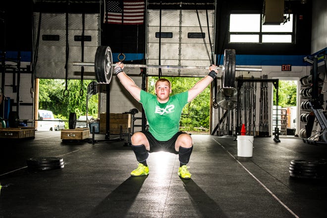 St. John's High football captain Sam Norton works out at Crossfit EXP in Leominster last week.