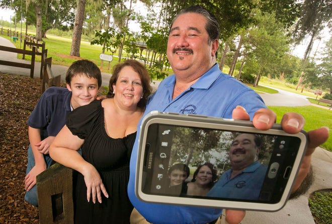 Khoi Ha, right, takes a selfie of him and his family — Austin Mellucci, 13, left, and Marcy Mellucci, center — at the Cross Florida Greenway Baseline Trailhead in Ocala. Ha came up with the idea for a No Selfies Day.