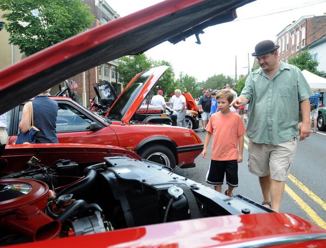 Thomas and Colin, 10, Chaar of Newtown Township look at a 1968 Oldsmobile during the annual Newtown Business Association Antique & Classic Auto Show on Sunday along State Street in the borough.
