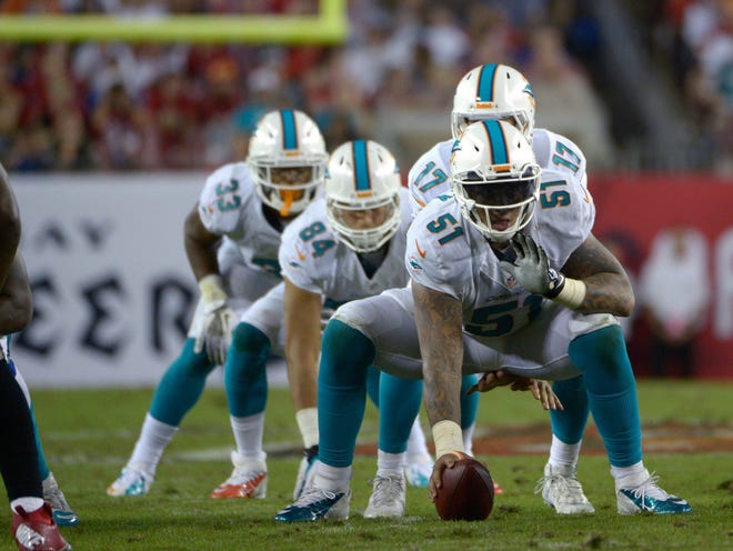 Center Mike Pouncey (51), who is injured, is the only player on Miami’s offensive line who is returning this season. The Dolphins hope some new faces can cut down on the franchise-record 58 sacks allowed from last season.