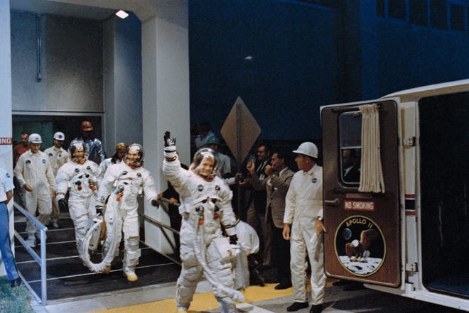 In this July 16, 1969 file photo, Neil Armstrong, waving in front, heads for the van that will take the Apollo 11 crew to the rocket for launch to the moon at Kennedy Space Center in Merritt Island, Fla. NASA renamed the historic building at Florida’s Kennedy Space Center on Monday, July 21, 2014, in honor of Armstrong, the first man to step foot on the moon 45 years ago.