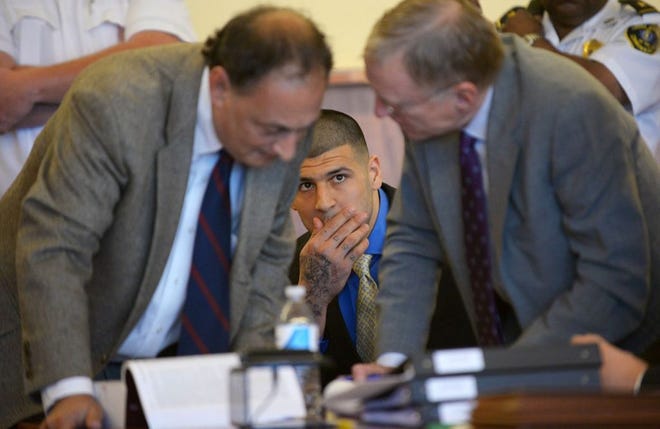 In this file photo, former New England Patriots player Aaron Hernandez watches his defense attorneys James Sultan and Charles Rankin during a hearing at Bristol County Superior Court, June 16 in Fall River.