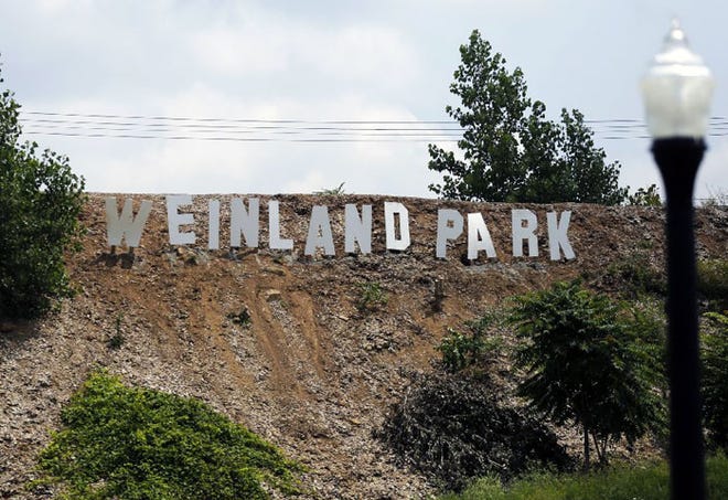 A Weinland Park sign, similar in style to the famous Hollywood sign, seen from N. Grant Avenue just north of E. 5th Avenue, hours before it was knocked down.
