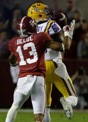 LSU wide receiver Jarvis Landry (80) makes the catch against Alabama defensive back Deion Belue (13) during the first half of an NCAA college football game, Saturday, Nov. 9, 2013, in Tuscaloosa, Ala.