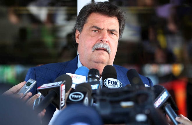 NASCAR President Mike Helton speaks outside the NASCAR hauler at New Hampshire Motor Speedway, Friday, July 11, 2014, in Loudon, N.H. Helton said there is no animosity from the governing body toward the recently formed, nine-team Race Team Alliance that will collaborate on initiatives and issues facing auto racing. (AP Photo/Jim Cole)
