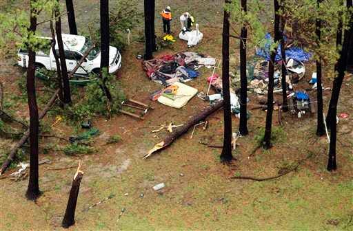In this aerial photo people inspect damage at Cherrystone Family Camping & RV Resort in Northampton County near Cheriton, Va., after a severe storm swept through the area. Softball-sized hail and rain toppled dozens of trees and flipped recreational vehicles at the campground Thursday, killing two people and injuring more than two dozen, officials said.